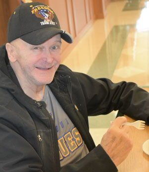 Veteran sitting at a table eating.